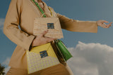 LINNETTE La Collezione Genesi 1960 collection with 3 handbags on a model