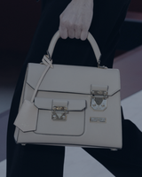 LINNETTE an image shows a white designer handbag with two buckles