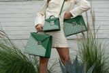 LINNETTE shows an image with a model with 3 green Silvia 1960 handbag